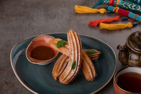 Churros with sugar and chocolate sauce, mint. traditional spanish dessertの写真素材