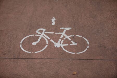 White Bicycle sign or icon on the road in the parkの写真素材