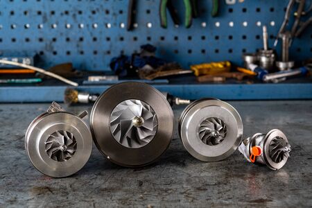 Parts of aluminum turbine close up. the new turbine for the diesel engine on a car workshopの写真素材