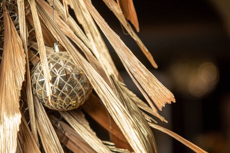 gold Christmas ball and golden fir tree. holiday background in retro vintage style