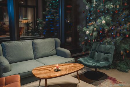 Interior of beautiful comfortable living room decorated for Christmasの写真素材