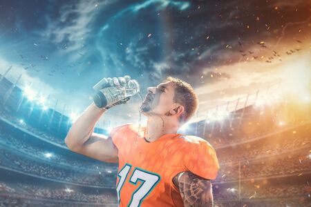 American football player drinks water at stadiumの写真素材