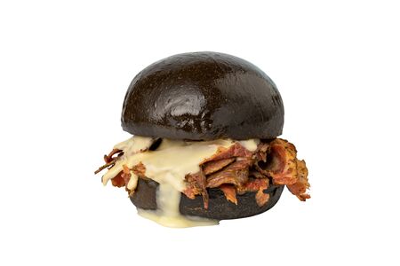 Large burger with a black loaf, melted cheese and bacon Isolated on whiteの写真素材