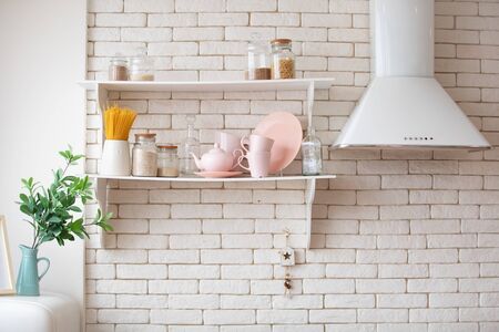 Opened cupboard with kitchenware inside. Scandinavian style kitchen interiorの写真素材