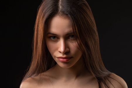 Fashion photo of beauty brunette woman with nude makeup on dark background