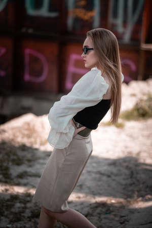 Portrait of modern stylish woman or girl posing on abandoned building. Woman with sunglassesの写真素材