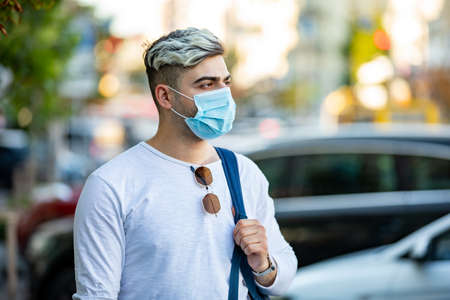 portrait of man smoking an electronic cigarette outdoor