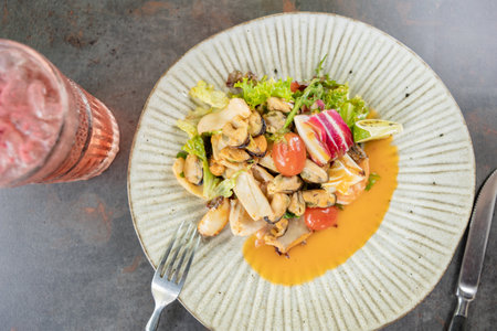 Salad of mussels and seafood with a cocktail served in the restaurant. gourmet food. top viewの写真素材