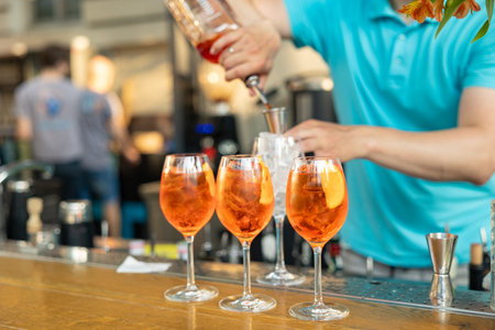 the bartender prepares a delicious Aperol spritz cocktails on the barの写真素材