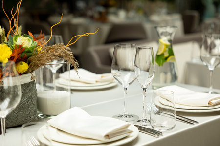 served table with empty dishes in a restaurant. autumn themeの写真素材