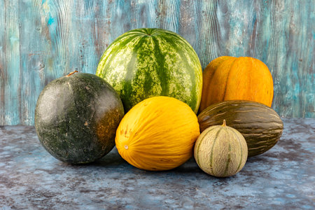 Melon, watermelon sliced on a blue background, vegetarian food, fruits, vegetables, organic healthy lifestyleの写真素材