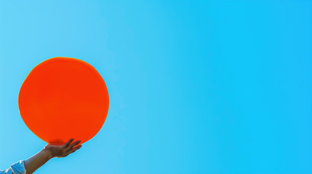 Art collage, the hand with a tray in an orange circle and on blue background with space for advertisement. Concept of serving something on a tray.の素材