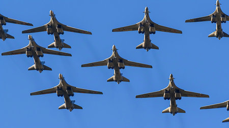 Column military warplanes flies over the ground in honor of the victory parade. Military planes in a beautiful blue skyの素材