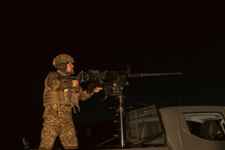 A soldier uses an anti-aircraft gun mounted on a pickup truck. Destroying air targets. Soldier's...