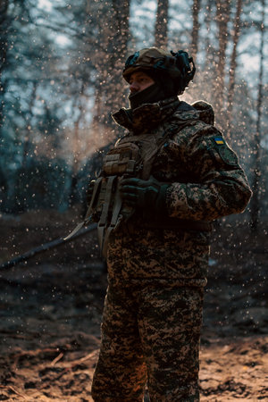 Portrait of a Ukrainian armed forces soldier in full equipment in the forest, concept of military conflict in Ukraineの写真素材
