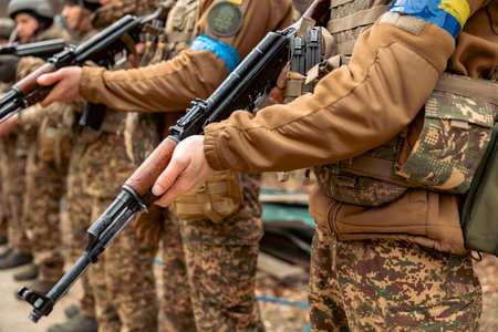 Machine guns in the hands of soldiers close up.