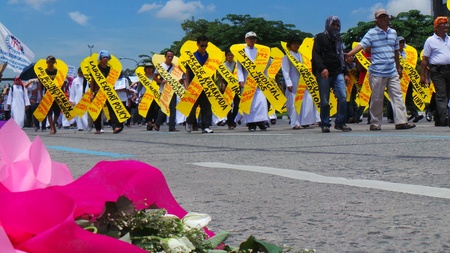 Policemen offers flowers to demonstrators but demonstrators throw the bouquet of flowers offered to...