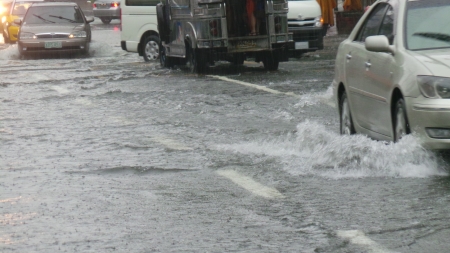 Vehicles passing through the flooded street   Flooding is brought by heavy rains created by Typhoon Trami and the seasonal monsoon rains のeditorial素材
