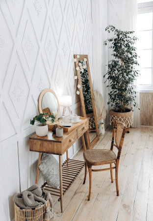 Wooden console table with vintage chair. Plant in a pot indoors. Scandinavian style handmade wooden furniture. Boho style interior. Nobodyの写真素材
