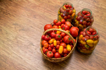 In the photo there is a basket with tomatoes. Fresh organic food from the garden. In the background...