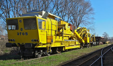 Yellow train sitting on tracks in rail stationのeditorial素材