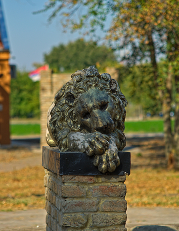 Bronze statue of a lion on bricks pedestalの写真素材