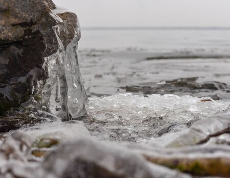 ice formation on a rock by the river