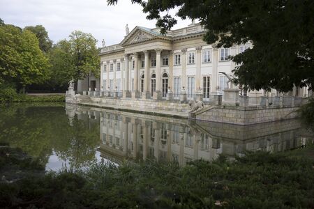 Royal summer Palace over the pond in Warsaw, Poland. Summer day, the facade of the Palace overlooking the boat dock in Lazienki Park. Site about architecture, history, parks.のeditorial素材