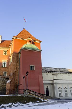 The area of ??the Old Town in city Warsaw, Poland. The southern facade of the Royal castle in winter. The tower is the Royal chapel with the Polish flag.のeditorial素材