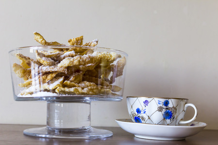 Sprinkle with powdered sugar, fried plate of shortcake dough. Dessert Polish and Lithuanian cuisine...