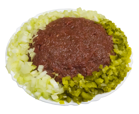 Steak tartare.The French cuisine. On a white plate with onion and pickles and on a white background.の写真素材