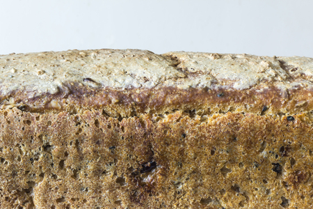 Homemade bread with cranberries and other additives. Polish cuisine. The crust of rye bread on a light background.の写真素材