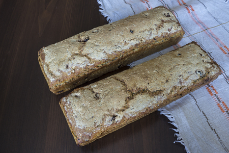 Two loaves of bread baked at home. Polish cuisine. . Rye bread on a linen napkin with folk embroidery.の写真素材