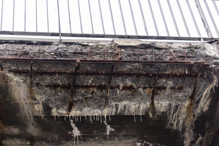 Corrosion of the concrete structure of the bridge due to the precipitation and chemical reagents. Formation mini stalactites and cavities.の写真素材