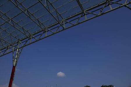 Detail of a glass canopy. The metal structure, clear glass and blue sky.	の写真素材