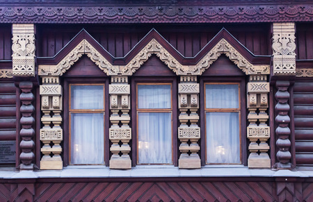 A window in a wooden log house. Decorated walls and window frames. Russia Moscow . The end of the 19th century.の写真素材