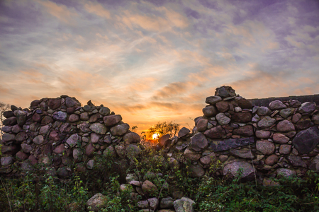 The destroyed barn wall on an agricultural abandoned farm. Sunset . Late autumn Podlasie, Poland.の写真素材