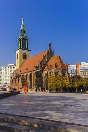 Evangelical Church of St. Mary. Medieval Gothic. Brick walls, clay tiles and a green bronze belfry. Berlin, Germany .の写真素材