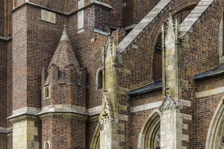 Details of the cathedral in the Gothic style. The side facade,flying buttress, sculptures,decor. Cathedral of St. John the Baptist in Wroclaw, Poland.の写真素材