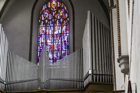 Interior of a cathedral in the Gothic style.A large  organ and a colored stained glass window in central nave.St.Mary Magdalene Church.Wroclaw,Poland.のeditorial素材