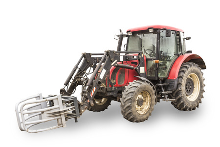 Tractor with hydraulic lift for carrying bales of hay and silage.Isolated photo of a general view of...