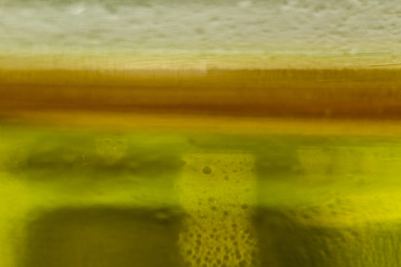 Macro photo. Plastic bottle . The level of yellow vegetable oil. Site about the kitchen, photography, art, abstraction, food industry.の写真素材