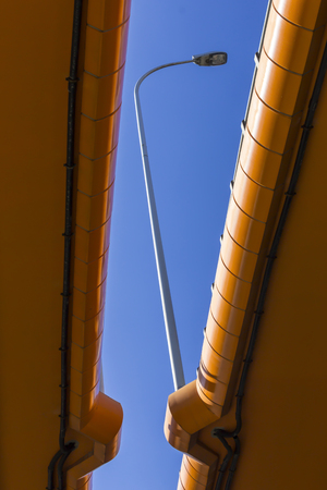 Highway and colored concrete overpasses. Blue sky and metal lantern in the gap. Modern technology in Warsaw, Poland.の写真素材