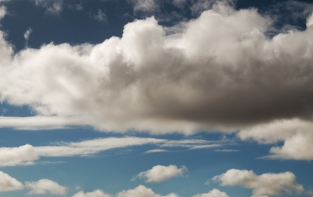 Cumulus clouds threatening rain with blue sky backgroundの写真素材