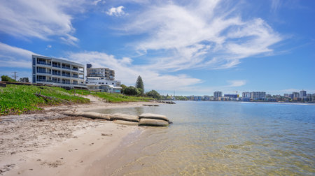 View of  calm waters of Pumicestone Passage at Golden Beach looking towards the highrise buildings of Caloundra on the Sunshine Coast Queensland Australiaの写真素材
