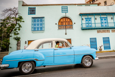 Old blue American car driving urban Cuban capital cityのeditorial素材