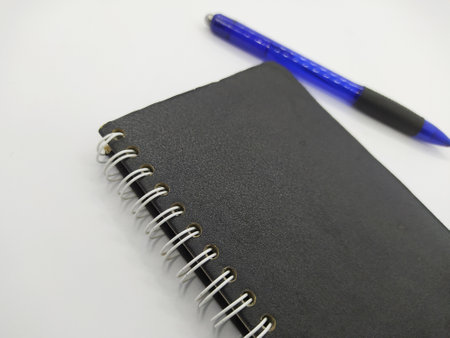 Notebook and pen on white background, business and education concept.