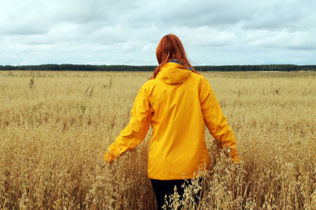 red-haired girl in the fieldの写真素材