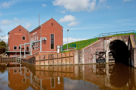 Regulatory sluice by a sea wall and pump houseのeditorial素材