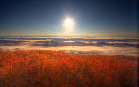 view at sunrise from fire tower overlooking mountains, valleys, fog and beautiful fall colors
